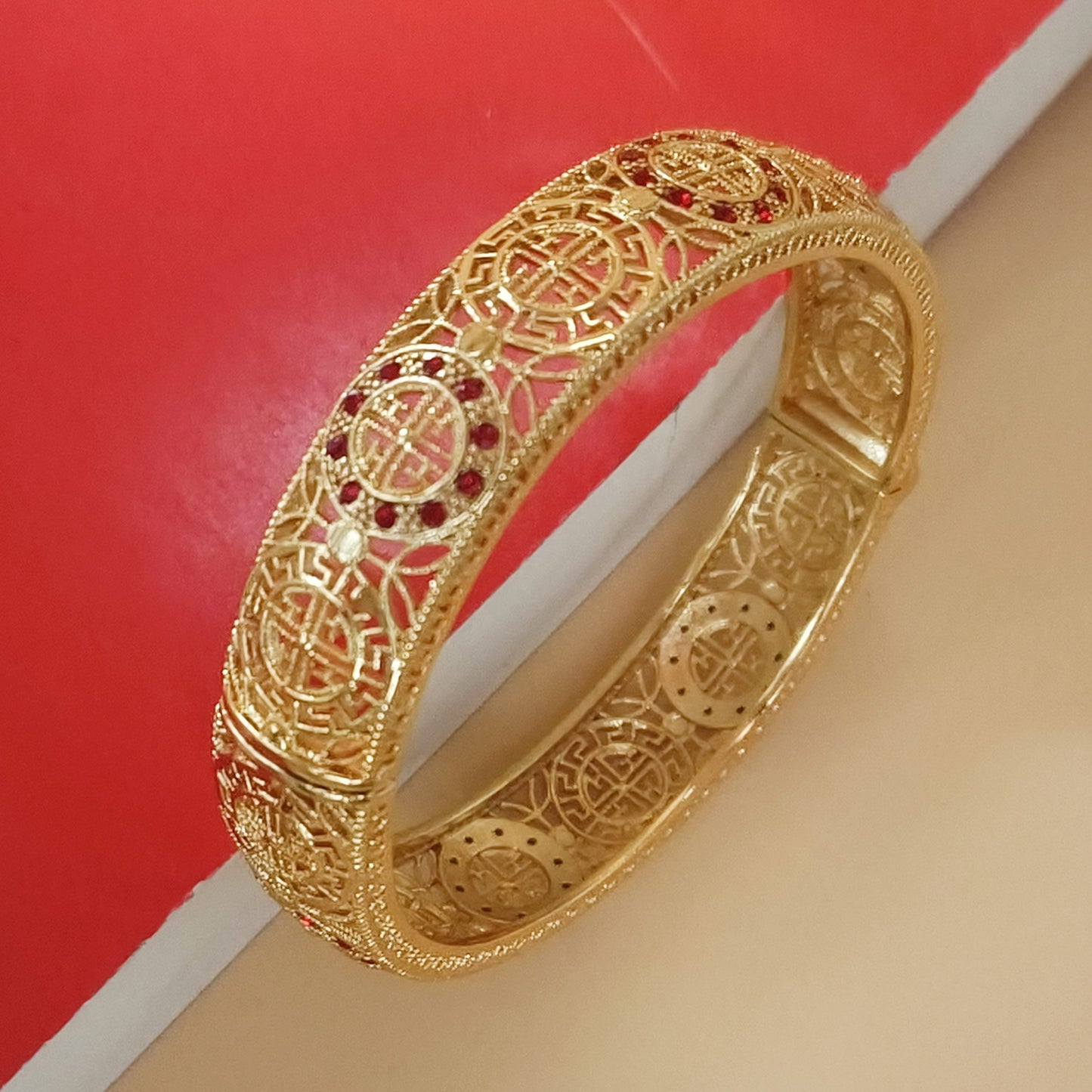 Gold plated lattice detail bangle with stones